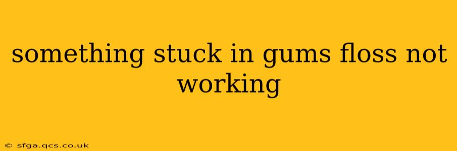 something stuck in gums floss not working